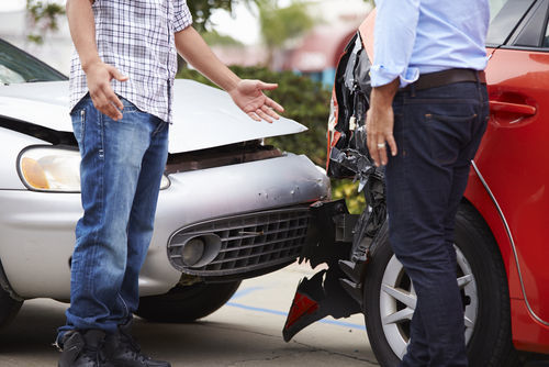 two men talking after a car collision - getting car repair bills paid should be part of any settlement in Colorado