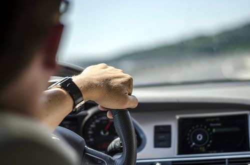 man driving a motor vehicle