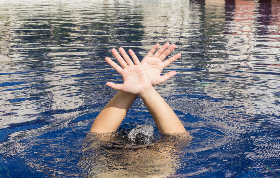 Drowning victim showing distress signal in the water