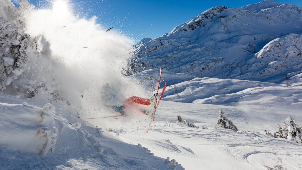 Skier falling down on snowy mountain